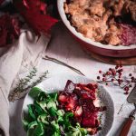 Tarte mit Roter Beete, Zwiebeln und Salat auf einem Teller